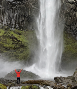 Man standing near water at Latourell Falls
